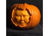 An orange pumpkin has been carved into a strange face