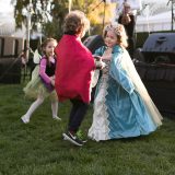 three young children dancing in Halloween costumes