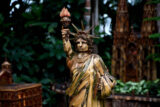 A small replica of the Statue of Liberty recreated using dried plant parts
