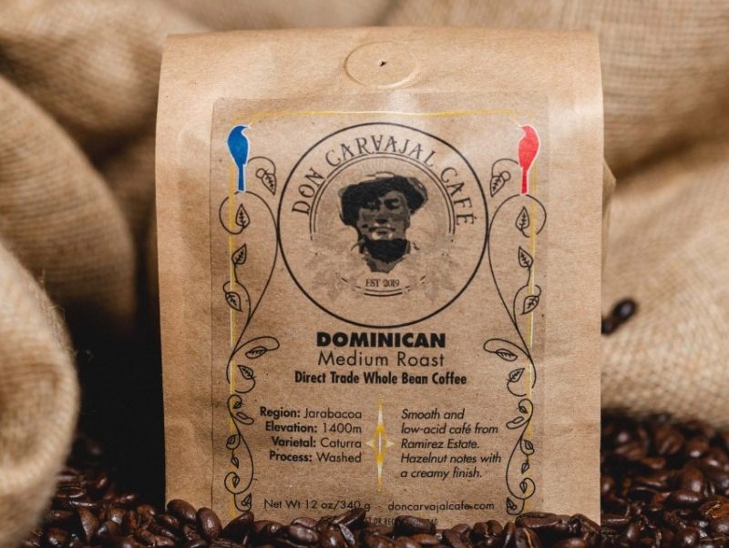 Packaged coffee sits among piles of fresh-roasted beans