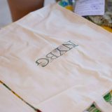a canvas tote bag with the NYBG logo stamped on it in green