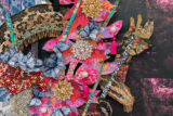 A collection of floral and butterfly elements worked into a collage of gold, blue, orange, and pink