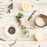 An image of lavender, mix of herbs and lemon on a table