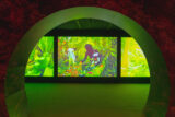 A view of an illuminated green screen selection through a circular gateway
