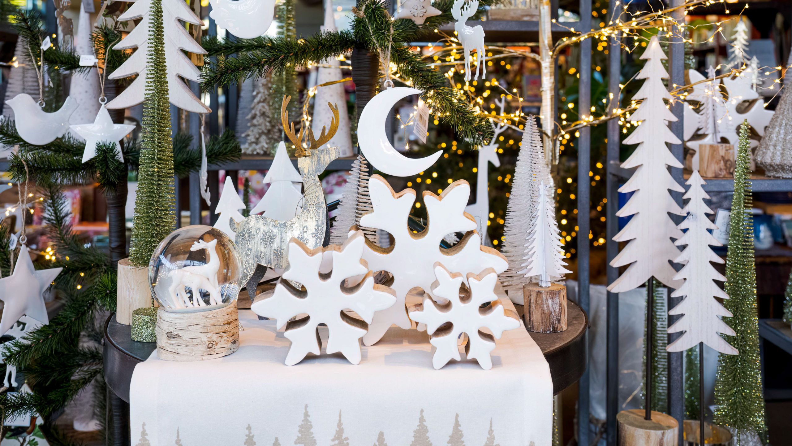 Holiday items in the shop, including a snowglobe, snowflake decorations, and small trees.