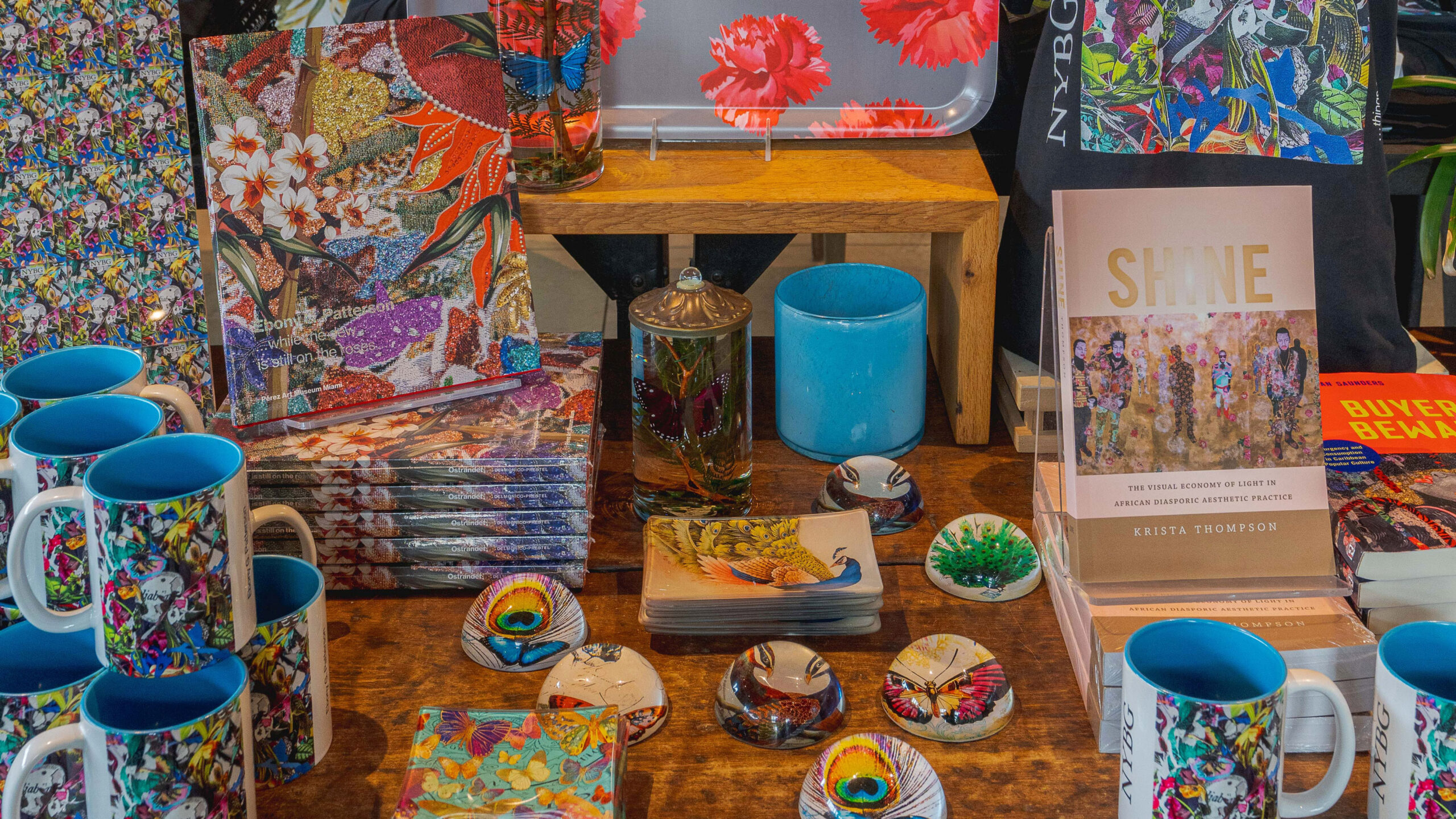 A selection of brightly colored home goods, books, napkins, paper weights, and more