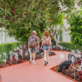 Two visitors walking through the Ebony G. Patterson exhibit in the Conservatory.