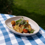 Caribbean dish of Sweet Plantains with tomatoes and onions from Hudson Garden Grill's menu