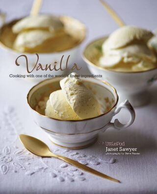 A cookbook depicting vanilla ice cream in small tea cups with gold spoons