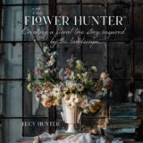 A chiaroscuro book cover featuring a white and green floral arrangement and the title "The Flower Hunter"