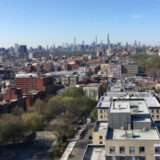 An aerial view of a city skyline under a blue sky