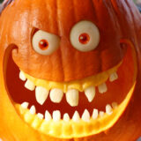 a close up shot of a jack-o-lantern with a mischievous grin
