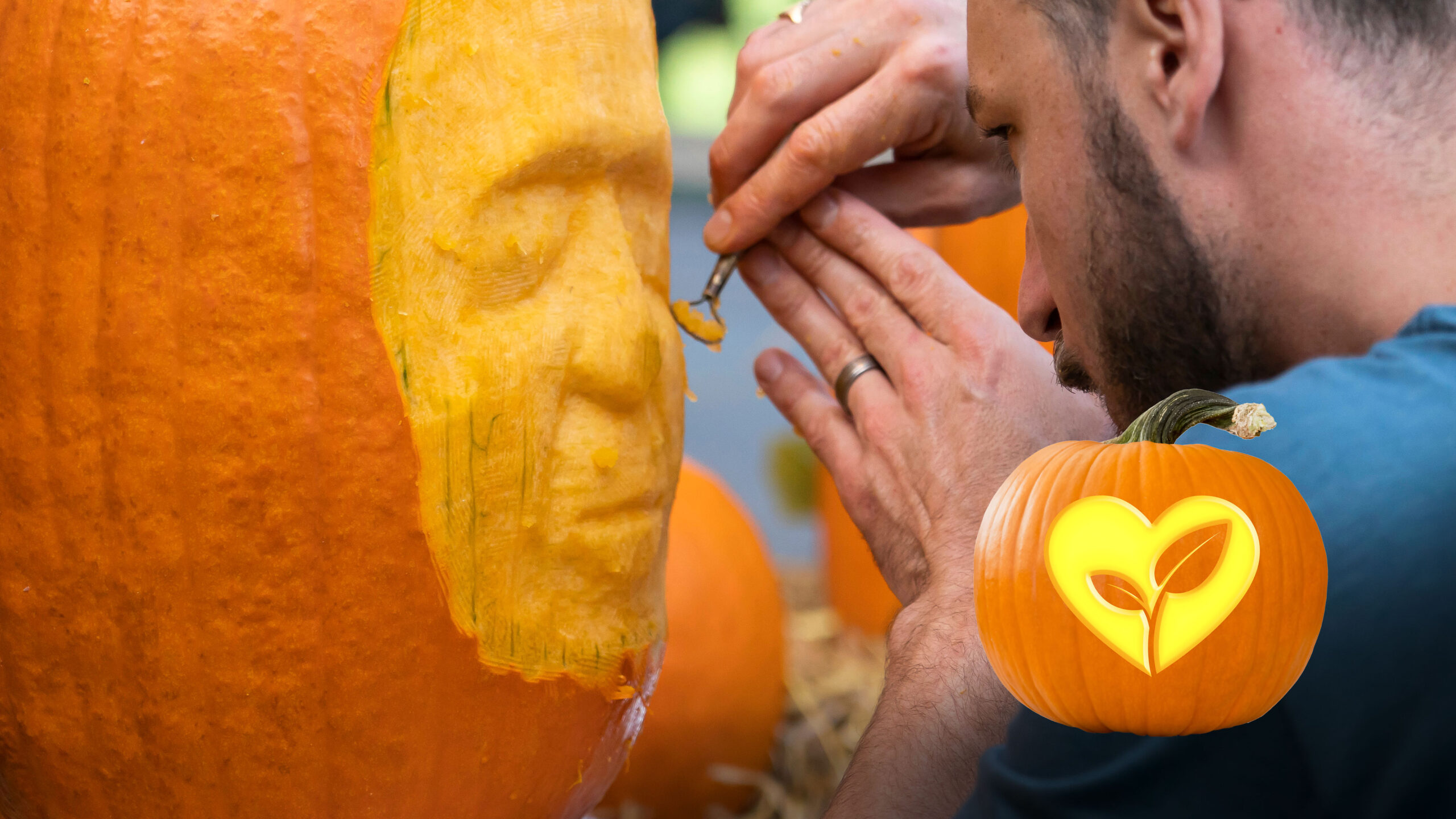 a person carving a face into a pumpkin; an animated small pumpkin in the bottom right corner with a plant design carved into it