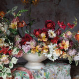 A red and white painting of a still life depicting a flower arrangement