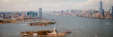 An aerial view of the New York City skyline, with the Statue of Liberty and One World Trade visible