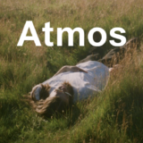 An image of a person lying down in a field of grass with the words 'Atmos' over them