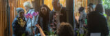 People learn about orchids in a conservatory setting