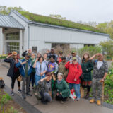 a group of veterans salute for a picture at the Edible Academy