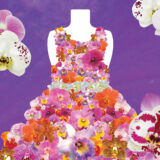 A dress fashioned from dozens of pink and red orchids against a purple backdrop