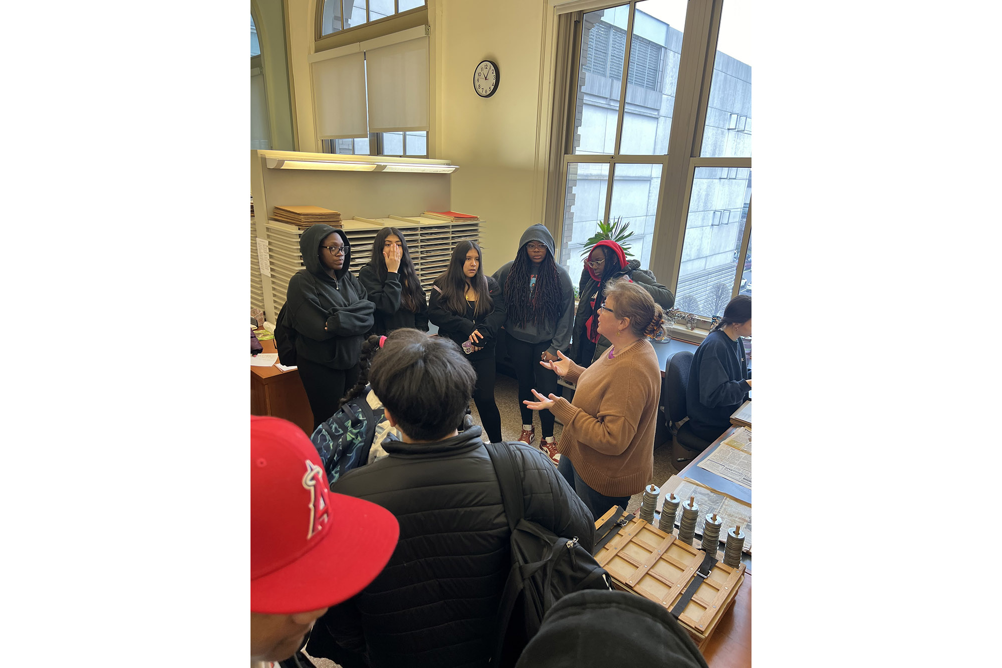 Students gather around a tour guide for an herbarium exploration