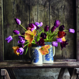 An arrangement of purple and orange tulips
