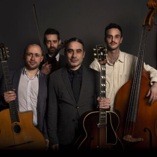 A group of four musicians poses with string instruments