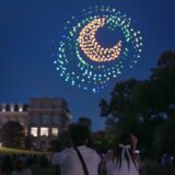 Visitors watch the drone show finale during Starry Nights