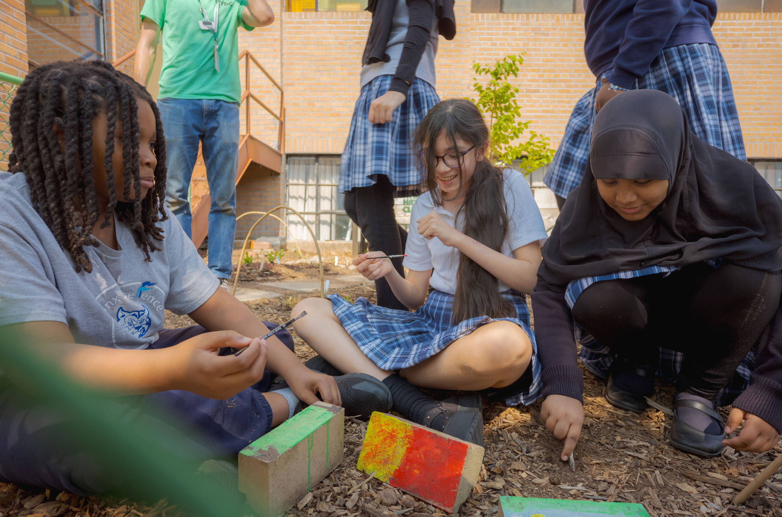 Children plant in a sunny school garden