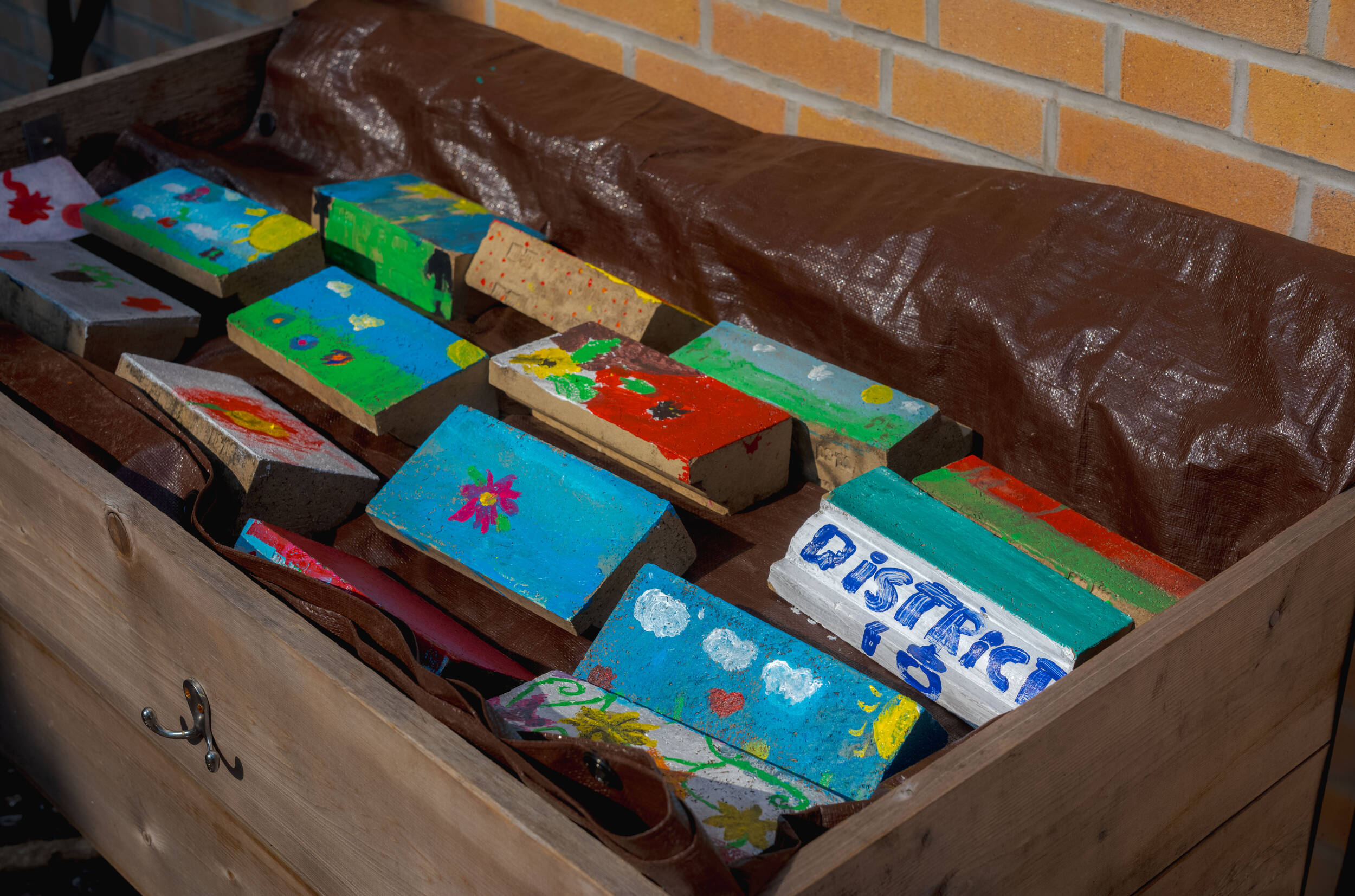 A box of colorfully painted bricks