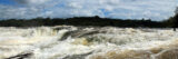 White-capped river rapids under a blue sky