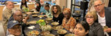A group of people seated for dinner around a long dining table