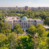 An aerial photo of a classical building surrounded by green trees
