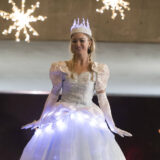 A person in a bright white gown poses for a photo