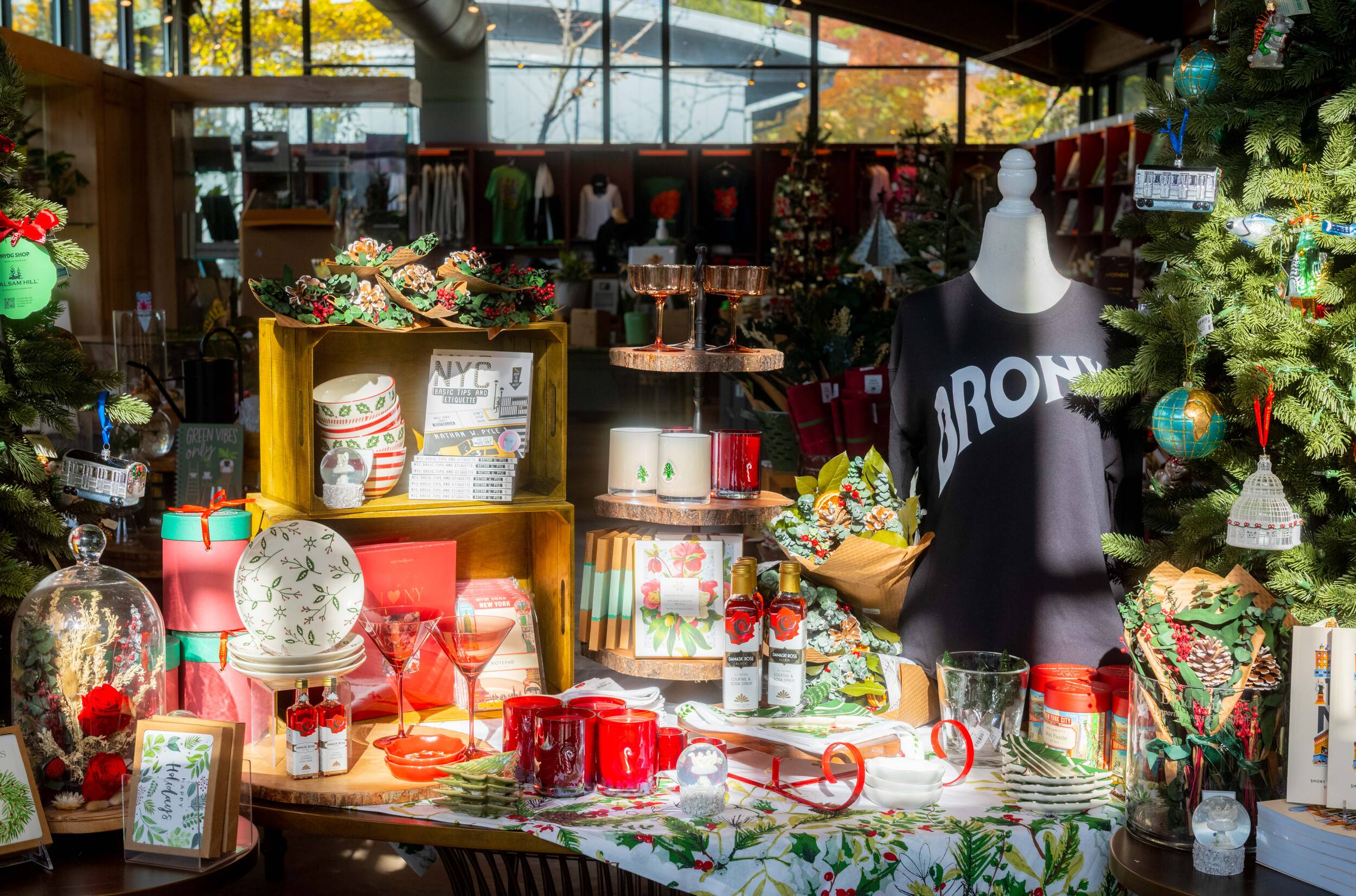 A collection of holiday themed items arrayed on a table in a sunny shop setting