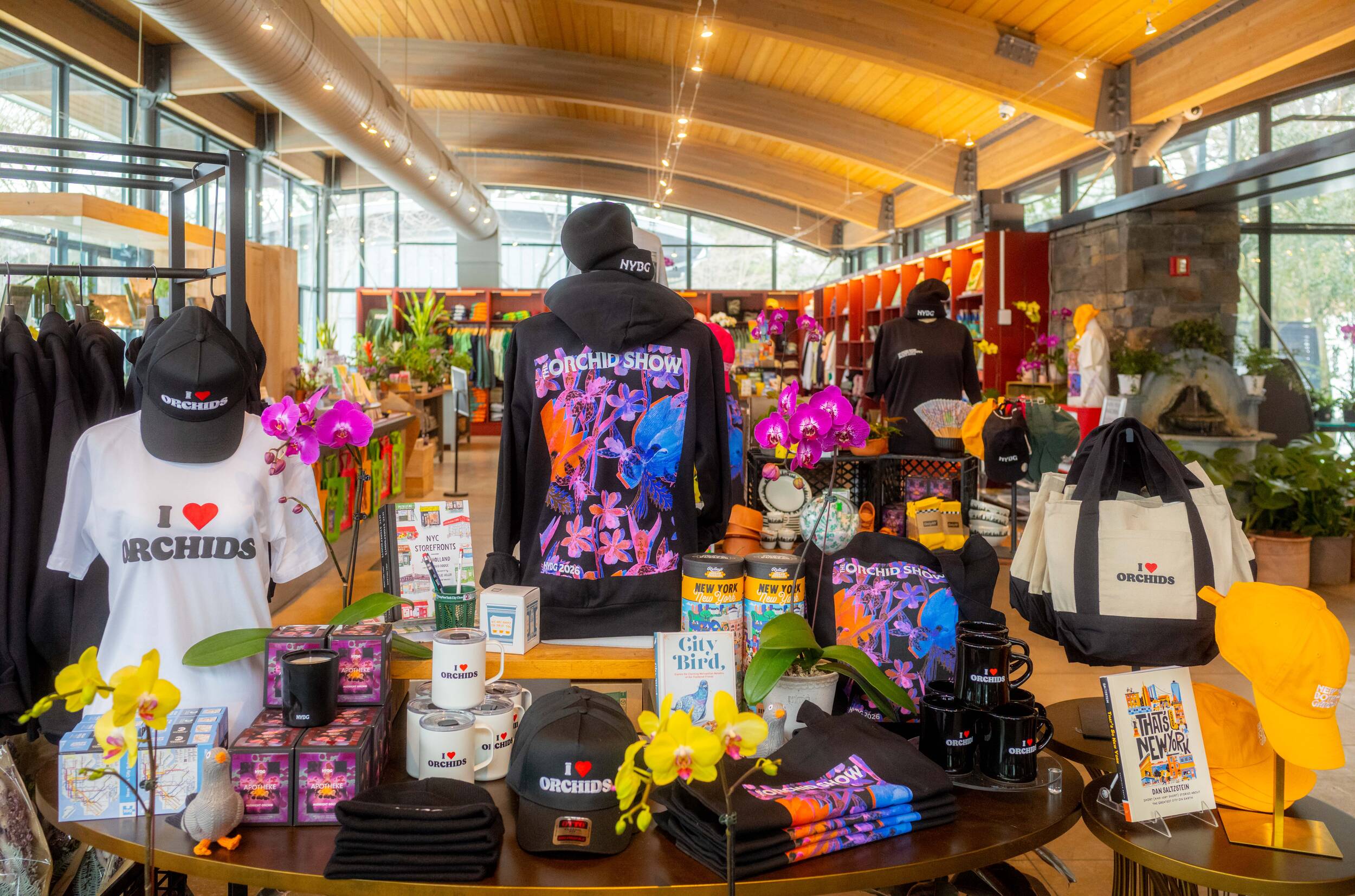 An arrangement of orchid-themed apparel and other merchandise arranged in a shop setting