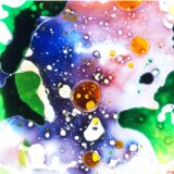 A colorful mixture of blue, red, and green fluids against a bright white background