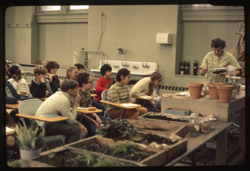 Students learn about plants in a classroom in this antique photo