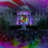 A colorful liquid light display projected onto a building