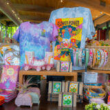 A selection of tie-dyed merchandise in a brightly lit shop setting