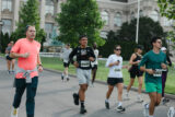 A group of people jogs in formation
