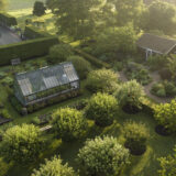 An aerial shot of a lush green farm at sunset