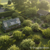 An aerial shot of a lush green farm at sunset