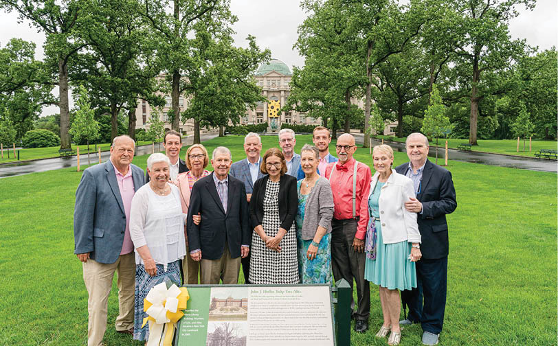 The family of John J  Hoffee stands around a plaque at the end of the newly rededicated Tulip Tree Allée 